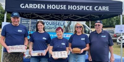 group-of-people-holding-cakes-at-a-charity-stall