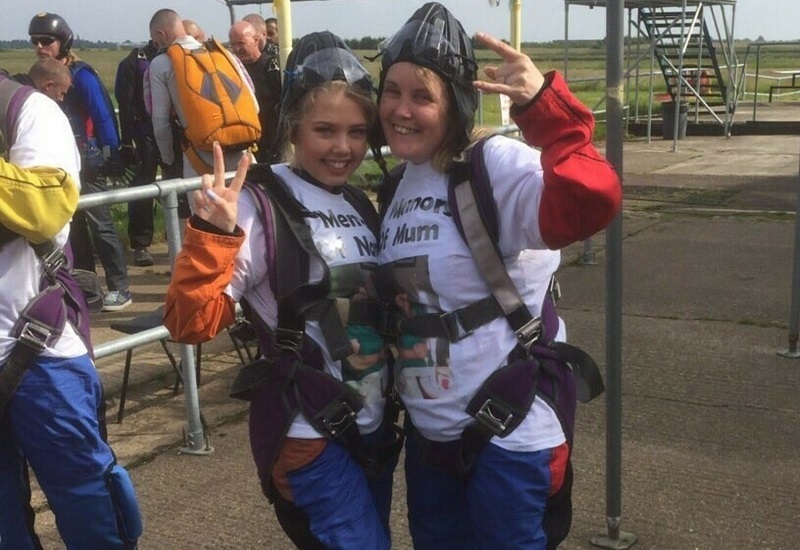 two-skydivers-wearing-harnesses-helments-and-matching-t-shirts