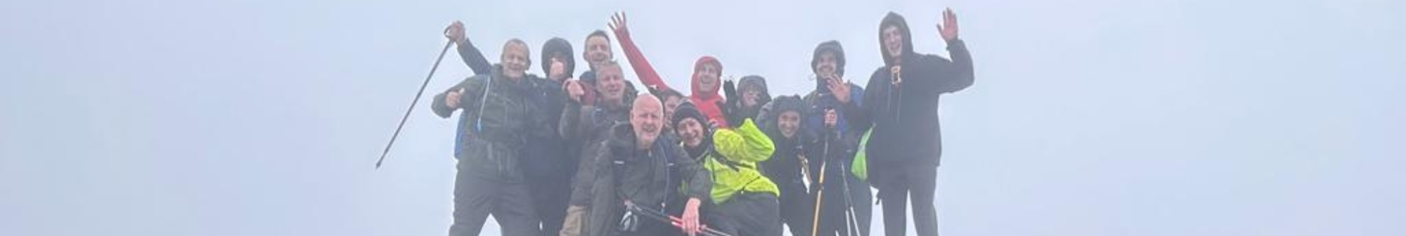 group-of-hikers-at-the-peak-of-a-mountain