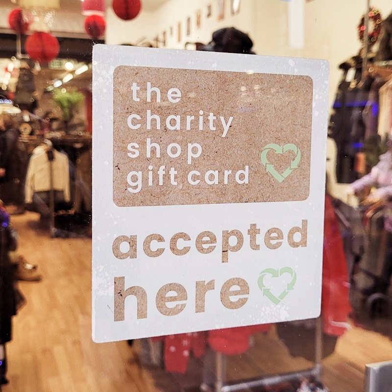 shop-window-containing-a-sign-that-reads-the-charity-shop-gift-card-accepted-here