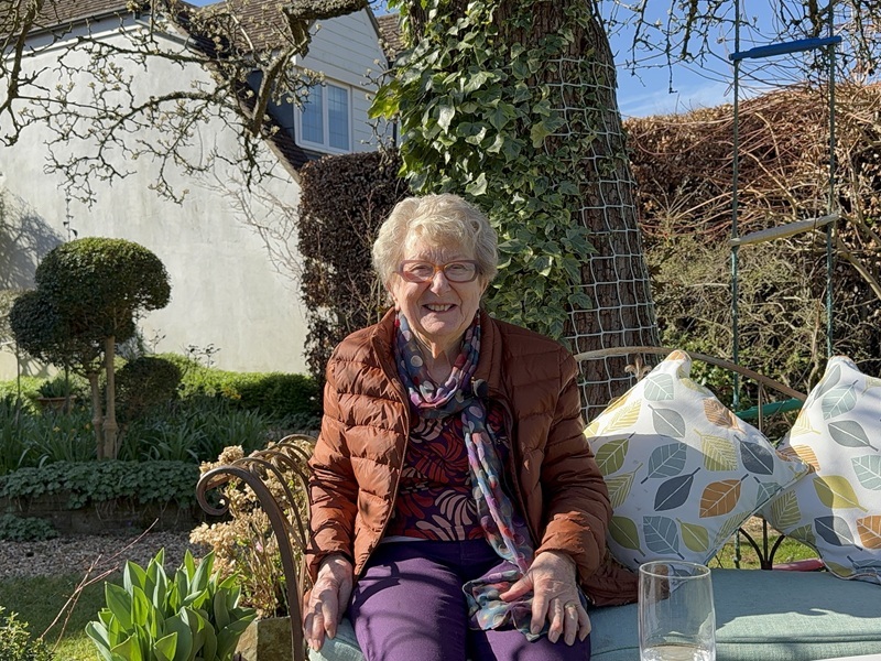 hospice-supporter-valerie-smiling-sitting-in-the-gardens