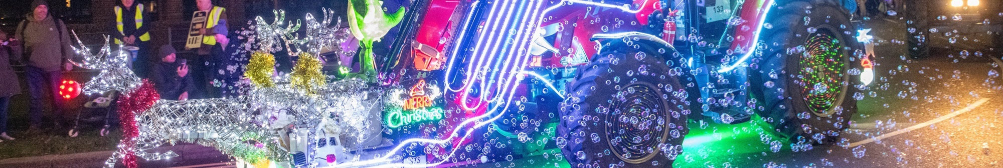 tractor-decorated-in-fairy-lights-reindeer-and-santa-blowing-bubbles-from-a-machine