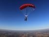 view-from-ground-of-skydiver-and-instuctor-high-in-sky