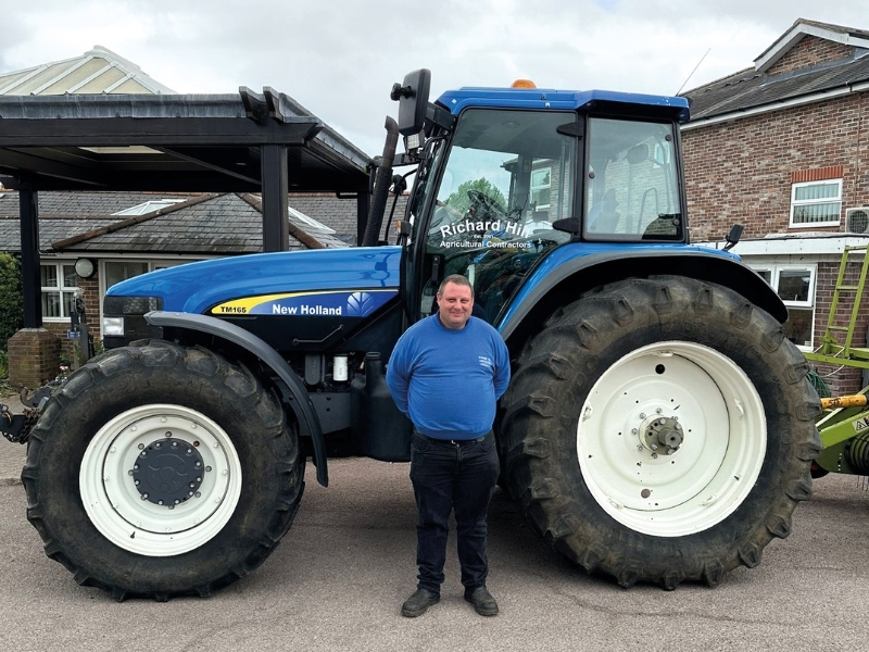 richard-hill-stands-in-front-of-tractor-outside-hospice