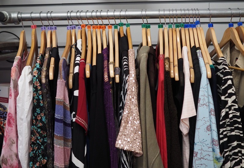 clothes-hanging-on-a-rail-inside-shop