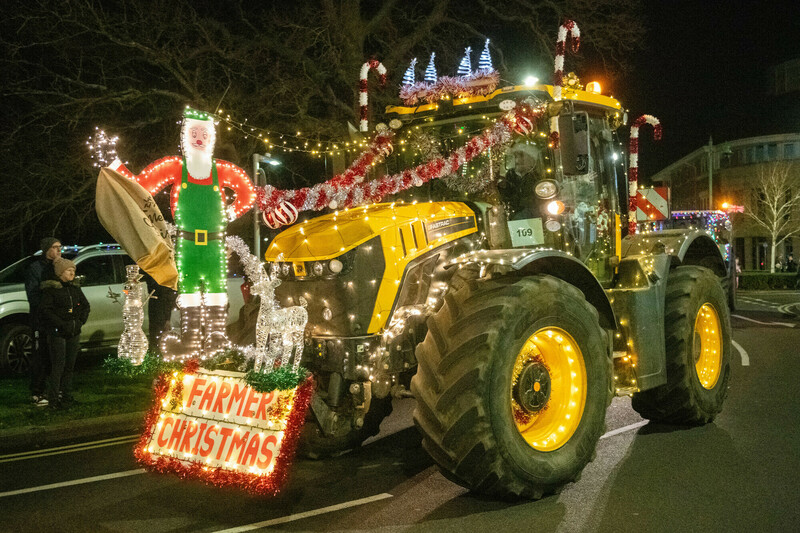 a-tractor-adorned-with-lights-and-a-farmer-christmas-figure