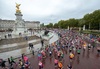 people-running-around-victoria-memorial-in-front-of-buckingham-palace