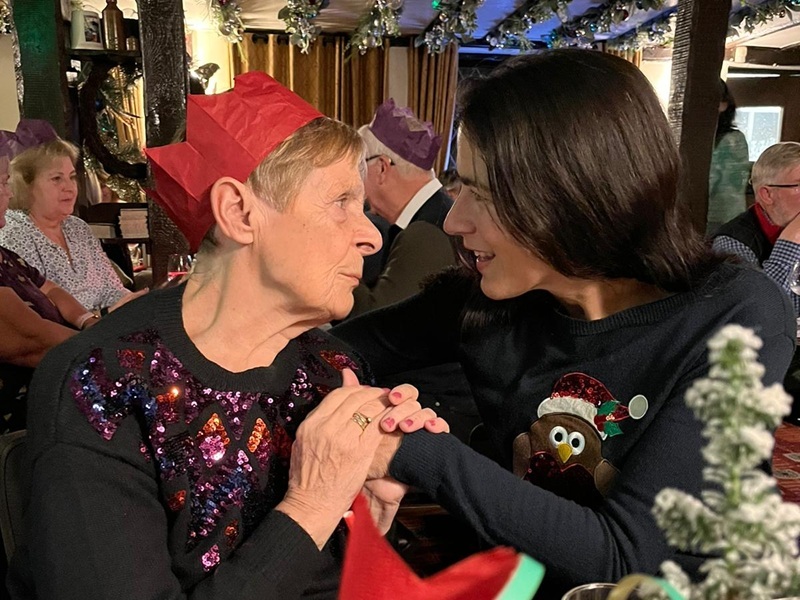 june-and-jules-hold-hands-at-the-table-at-christmas