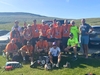 group-of-yorkshire-three-peaks-challengers-wearing-matching-t-shirts-and-finishers-medals