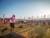 a-man-on-stage-leads-a-group-warm-up-at-the-kent-downs-50-ultra-challenge