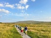 group-of-people-walking-along-path-on-yorkshire-three-peaks-challenge
