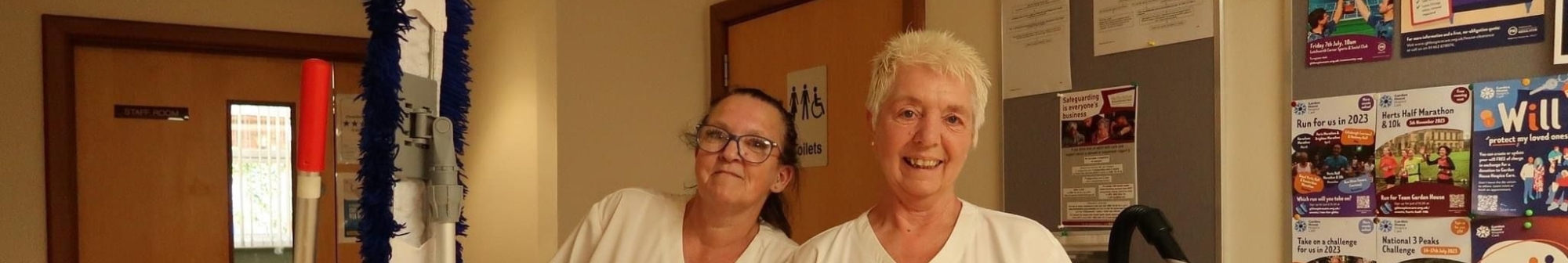 two-members-of-the-hopsices-house-keeping-team-smile-at-camera