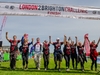 group-holding-hands-together-crossing-the-london-2-brighton-ultra-challenge-finish-line
