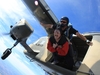 skydiver-smiling-with-wide-eyes-as-they-jump-from-plane