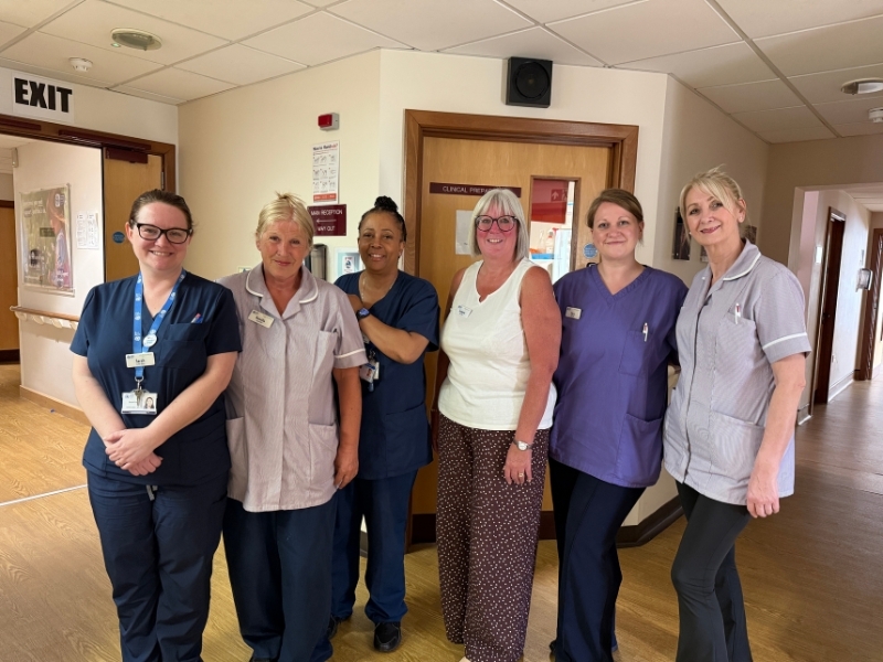 members-of-our-inpatient-unit-team-stand-in-a-line-smiling