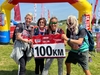 group-holding-a-100km-sign-in-an-ultra-challenge