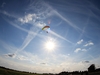 view-from-ground-of-skydiver-high-in-sky-above-the-sun
