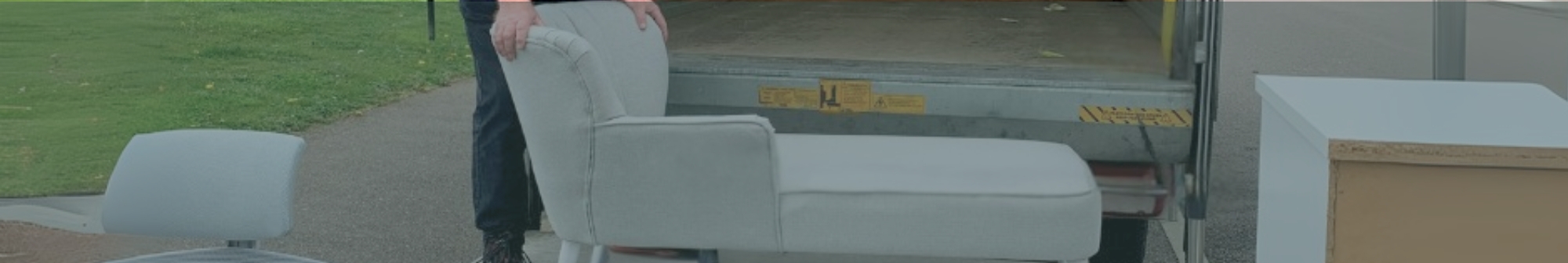a-sofa-being-loaded-onto-the-back-of-a-van