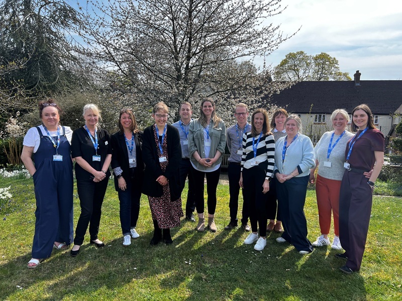 frailty-specialist-care-home-team-stand-smiling-in-the-hospice-gardens