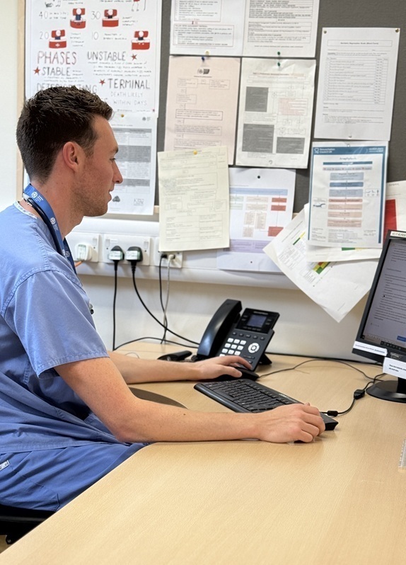 doctor-scrolling-through-notes-on-a-computer (cropped)