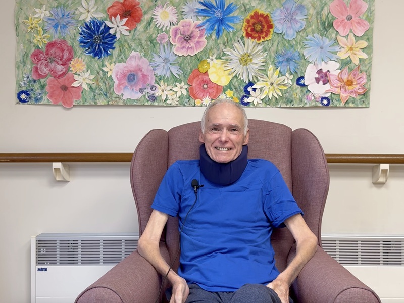 kent-sitting-in-a-chair-and-smiling-at-the-camera