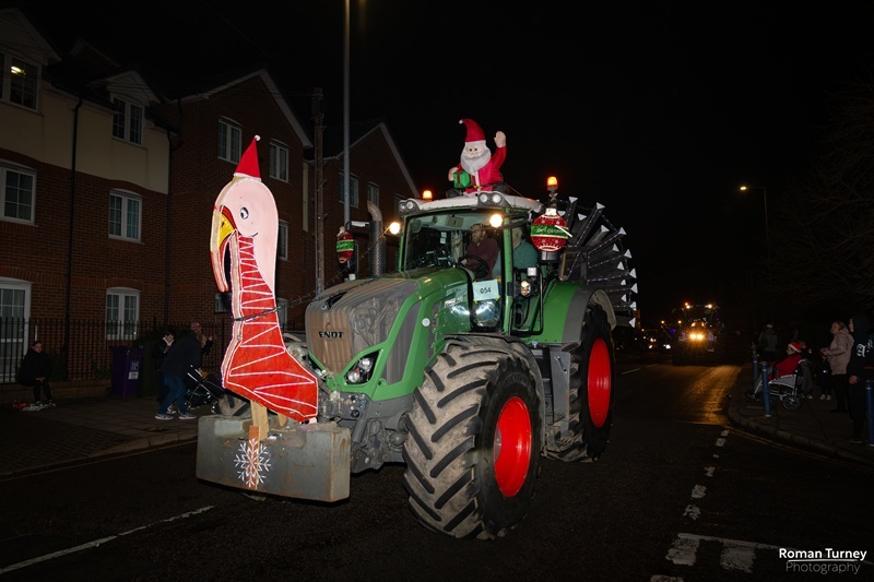 a-green-tractor-decorated-with-a-wooden-turkey-head-and-tail