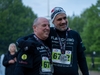 two-runners-smiling-wearing-medals-at-the-flawed-hero-marathon