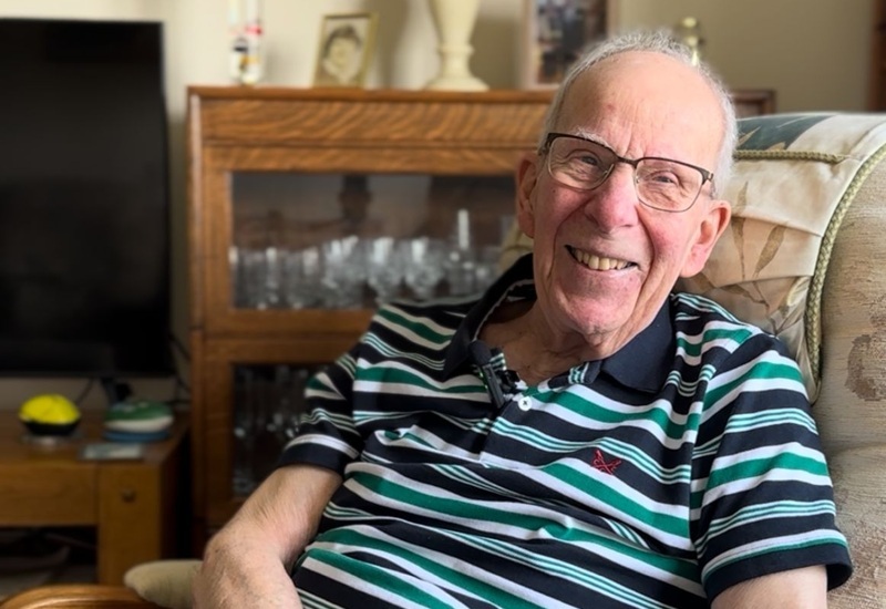 roger-sitting-in-an-armchair-at-home-smiling