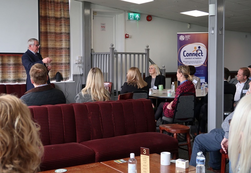 connect-members-sit-at-tables-listening-to-guest-speaker