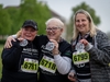 three-women-hold-up-finishers-medals-at-the-flawed-hero-marathon