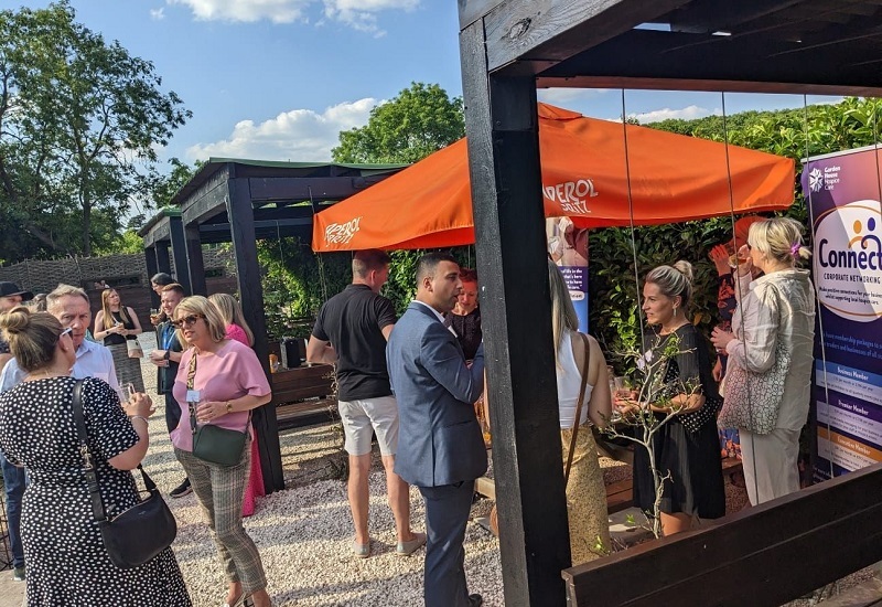 connect-corporate-networking-members-talking-outdoors-at-summer-social