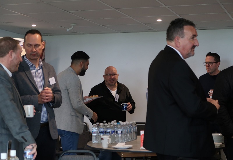 connect-members-stand-networking-around-refreshments-table
