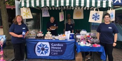 volunteers-manning-a-cake-stall-holding-collection-tins