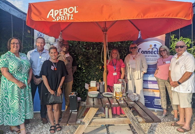 connect-members-pose-for-photo-outside-in-front-of-hospice-banners