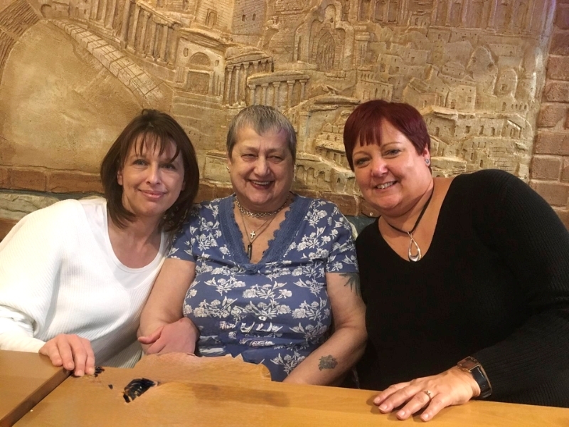 anna-sitting-at-a-table-with-daughters-kim-and-maria