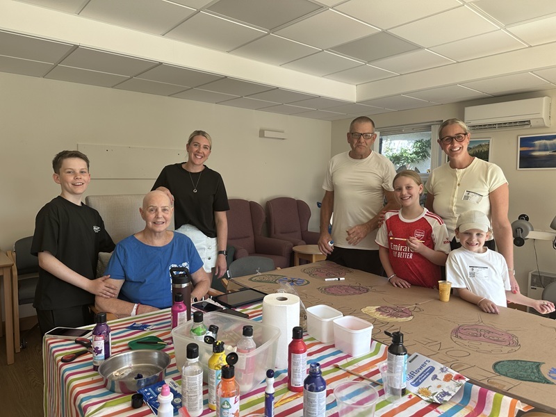 the-tooley-banks-family-painting-signs-in-the-hospice-gym