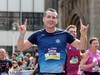 runner-making-rock-on-signals-with-hands-at-the-manchester-marathon