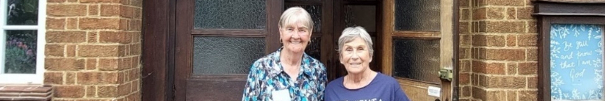 jo-and-sally-stand-together-outside-community-hub