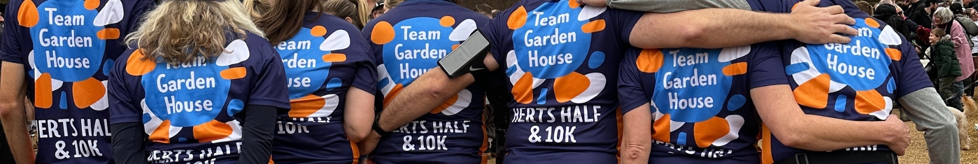 back-of-a-group-of-running-tops-reading-team-garden-house-herts-half-10k