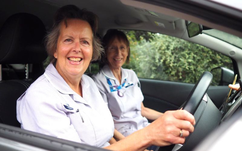 two-hospice-at-home-staff-sitting-in-a-car