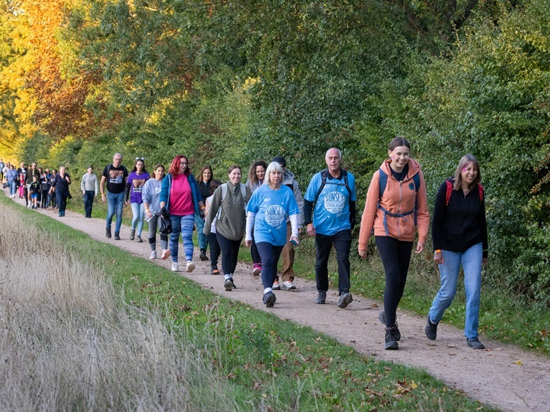 people-walking-down-a-path-at-sunset-starlight-walk