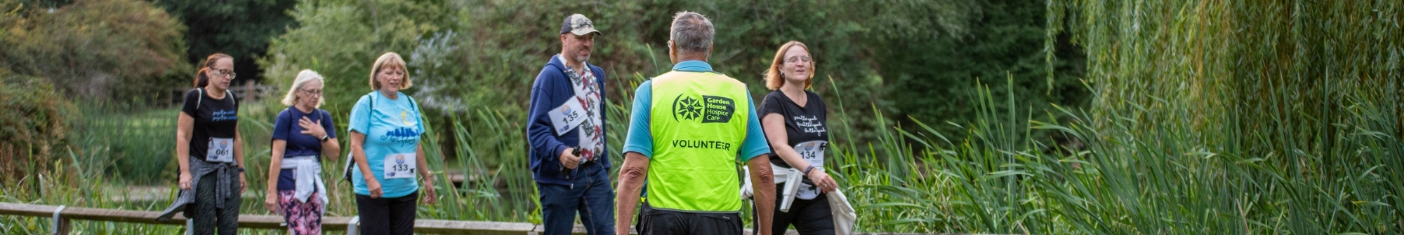 volunteer-marshall-guides-walkers-across-road
