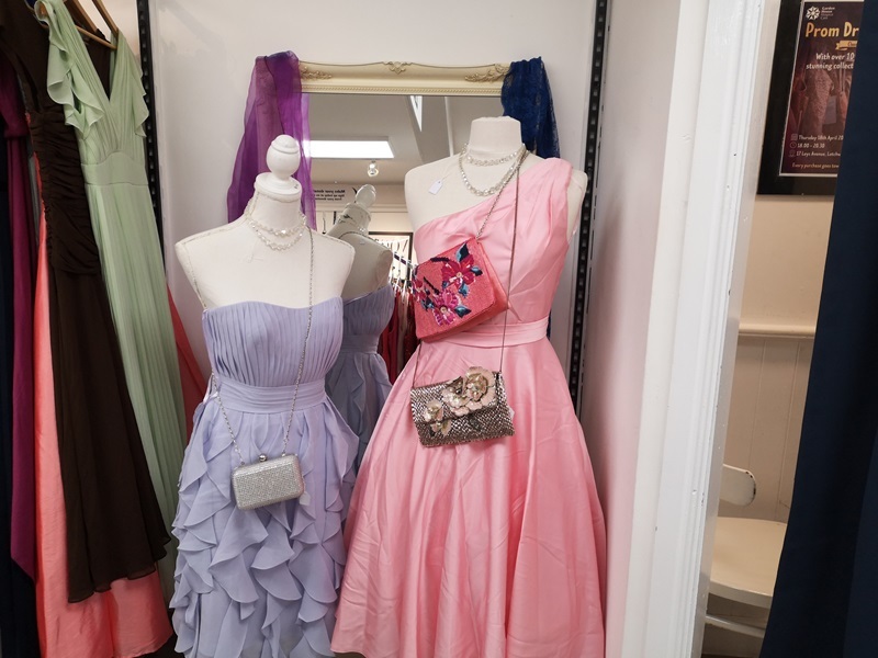 two-prom-dresses-hanging-on-mannequins-in-a-shop