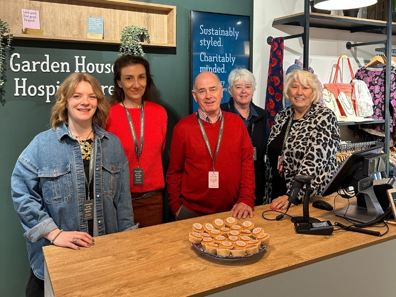 staff-and-volunteers-smile-behind-till-at-our-hitchin-shop