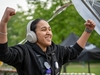 woman-wearing-headphones-pumps-fists-in-the-air--at-the-flawed-hero-marathon-finish
