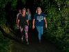 two-sunset-starlight-walkers-wearing-bright-leggings-and-glowsticks