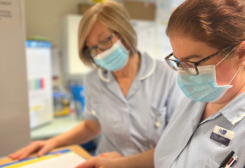 two-nurses-looking-at-notes-together