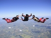 three-skydivers-in-the-air-before-opening-their-parachutes