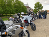 motorcycles-lined-up-in-letchworth-next-to-a-group-of-riders