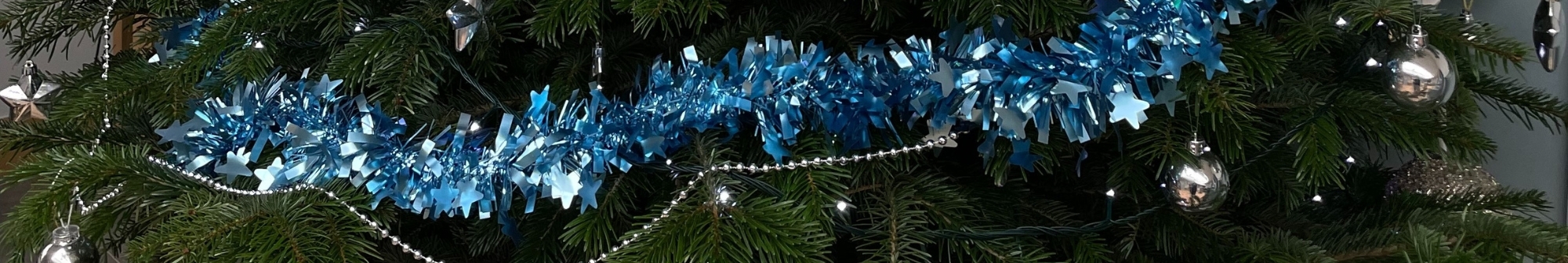 christmas-tree-decorated-with-blue-tinsel-silver-beads-and-baubles